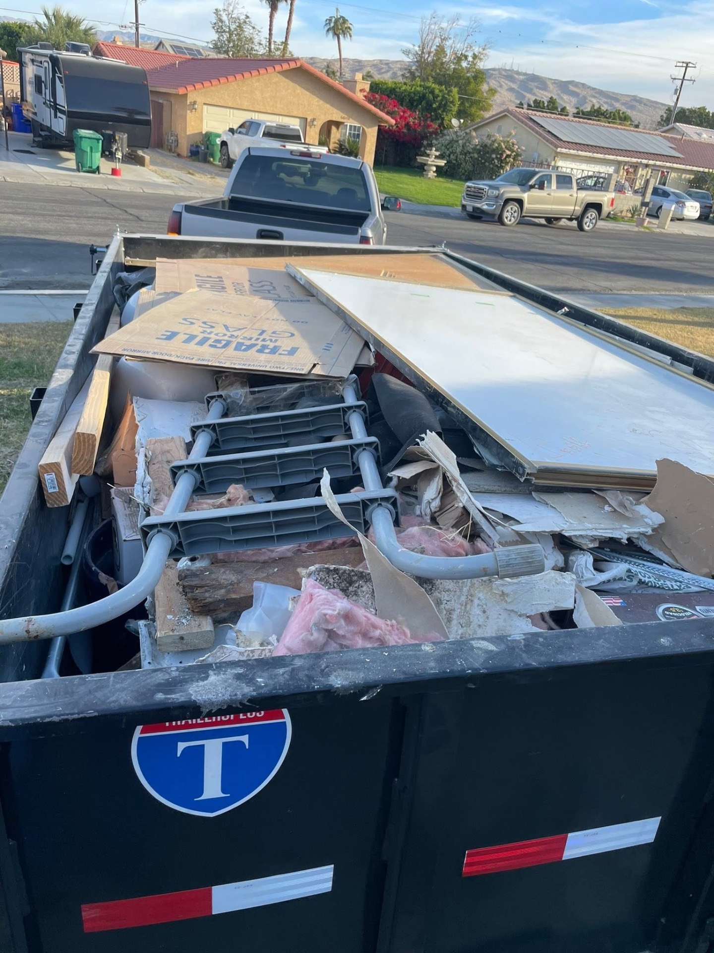 Jobsite dumpster loaded and hauled.